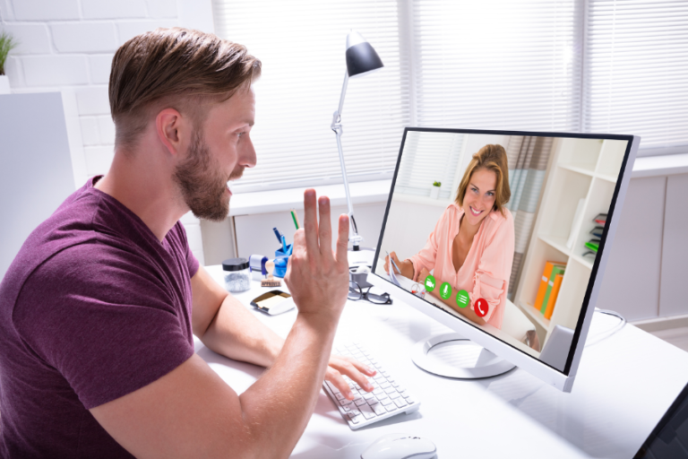 photo of a guy in front of a computer with a business coach